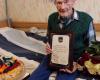Council chairman Egils Helmanis congratulates legionnaire Anton Mortukanas on his 105th birthday